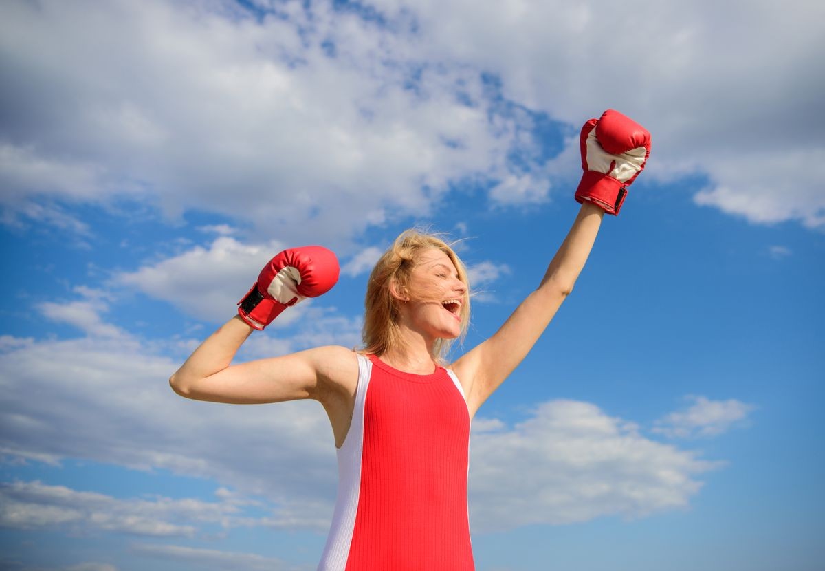 Girls power concept. Woman strong boxing gloves raise hands blue sky background. Girl boxing gloves symbol struggle for female rights and liberties. Feminism promotion. Fight for female rights.