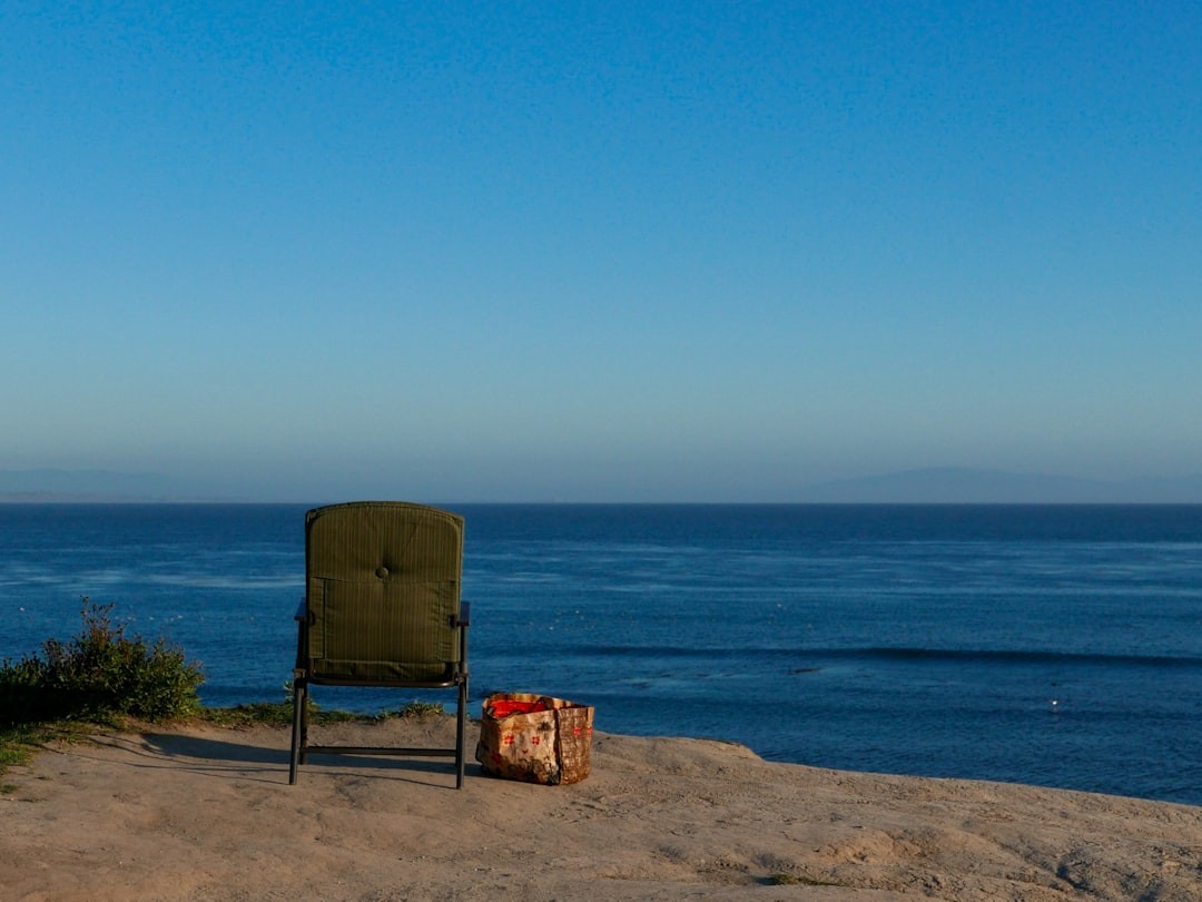 brown armchair near sea shore